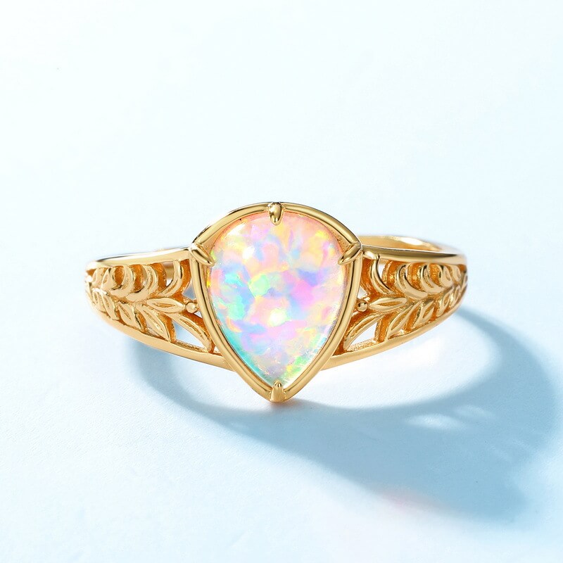 Carved gold opal jewelry ring symbolising purity, healing and gentle transformation.