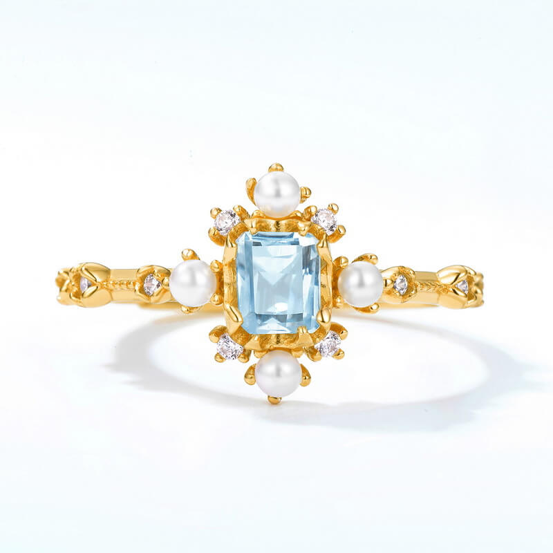 London blue topaz jewelry ring with pearls symbolising mystical elegance and lasting friendship.
