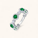 Emerald engagement ring with circular stones embodying faith and harmony.