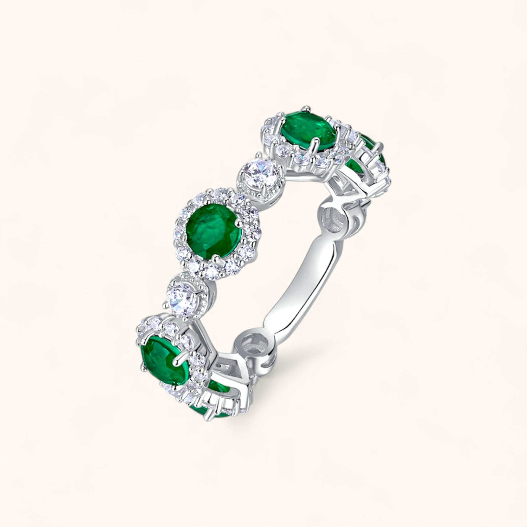 Emerald engagement ring with circular stones embodying faith and harmony.