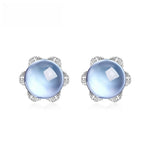 Flower-shaped sky blue topaz jewelry earrings representing softness, friendship and light.