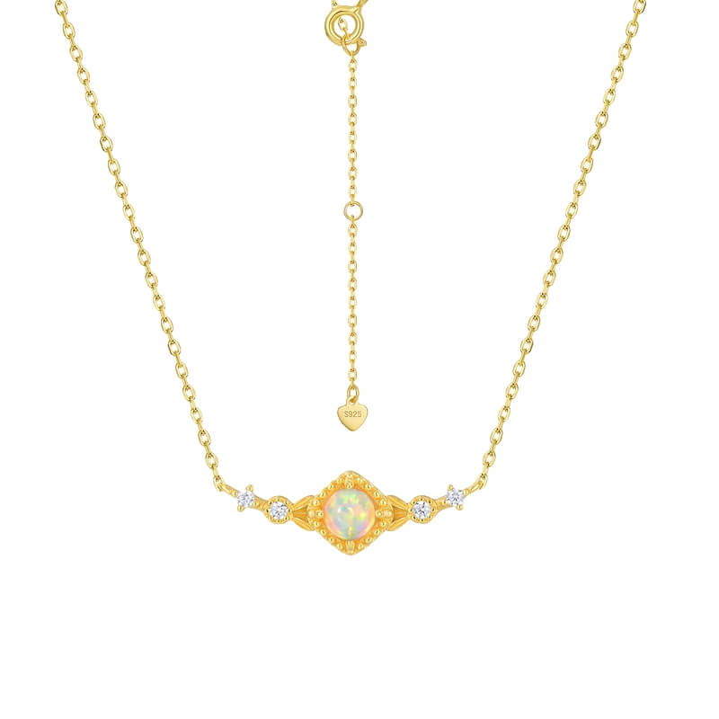 Three-stone opal jewelry ring in gold, representing emotional connection and self-love.