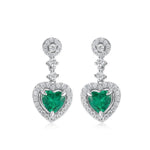 Heart-shaped emerald earrings radiating love and emotional renewal.