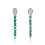 Snake-inspired emerald drop earrings reflecting mystery and feminine strength.