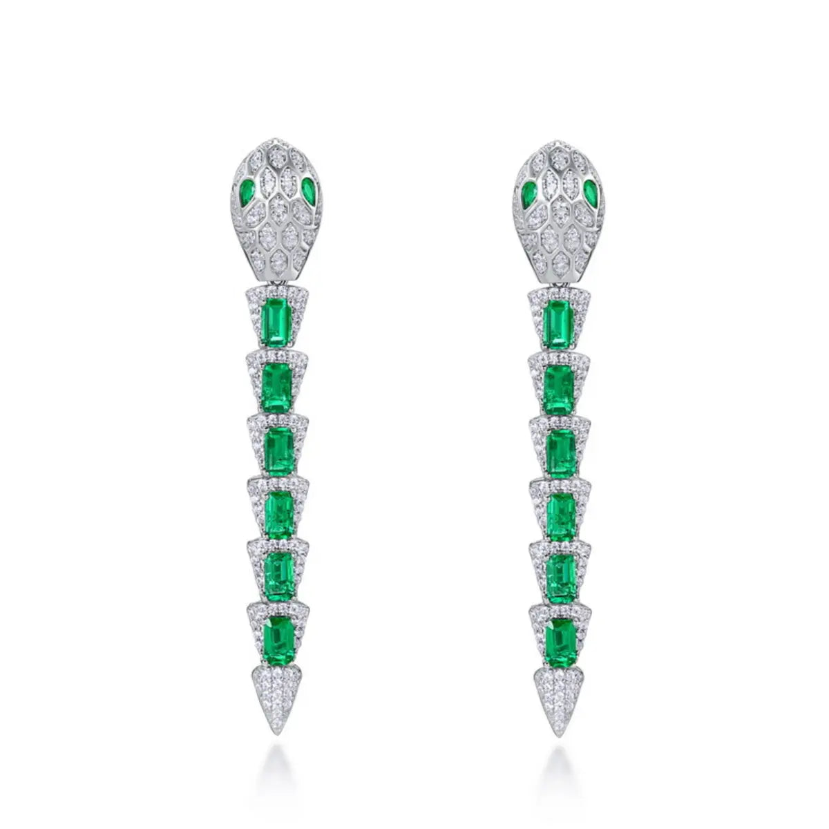 Snake-inspired emerald drop earrings reflecting mystery and feminine strength.