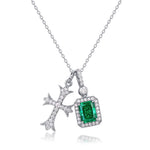 Emerald cross necklace combining faith and balance, handcrafted by Minerva Jewelry.