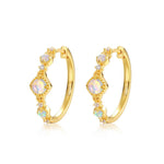 Gold halo opal jewelry earrings symbolising harmony, light and inner peace.