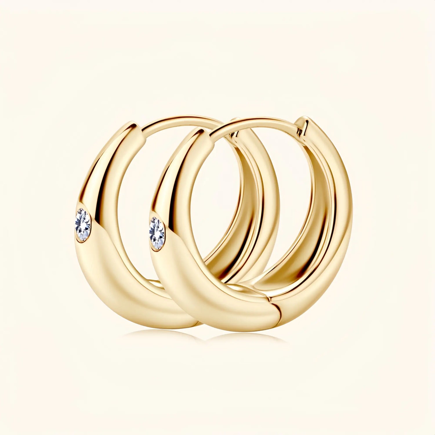 Gold moissanite hoop earrings representing harmony, confidence and enduring style.