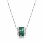 Circular moss agate jewelry pendant symbolising wholeness, nature and spiritual balance.