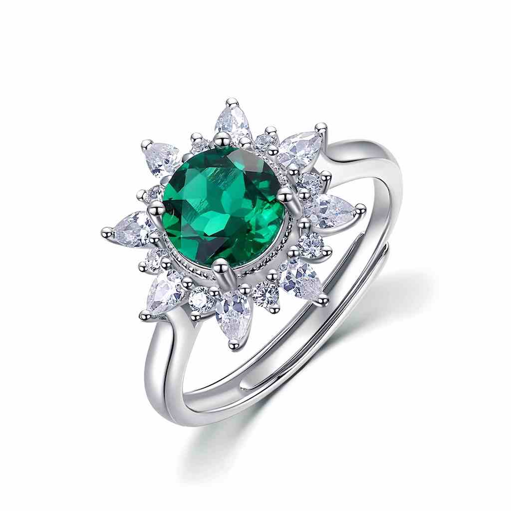 Round emerald ring with diamond halo, crafted to represent clarity and strength.