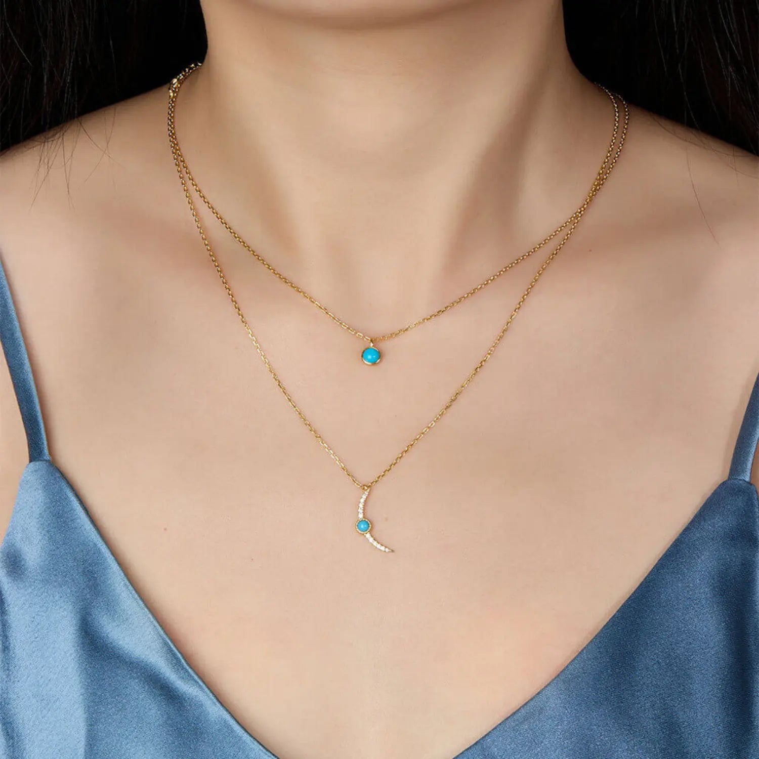 Layered gold turquoise jewelry necklace representing harmony, flow and good fortune.