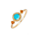 Turquoise jewelry ring with golden design symbolising vitality, optimism and joyful charm.
