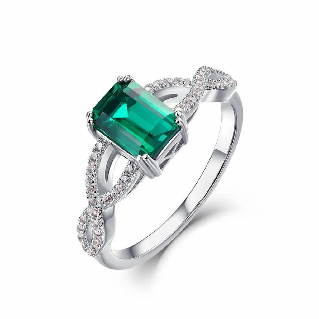 Vintage emerald ring reflecting timeless charm and harmony in silver tones.