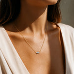Marquise-cut moissanite necklace with the stone set horizontally between two chain ends.
