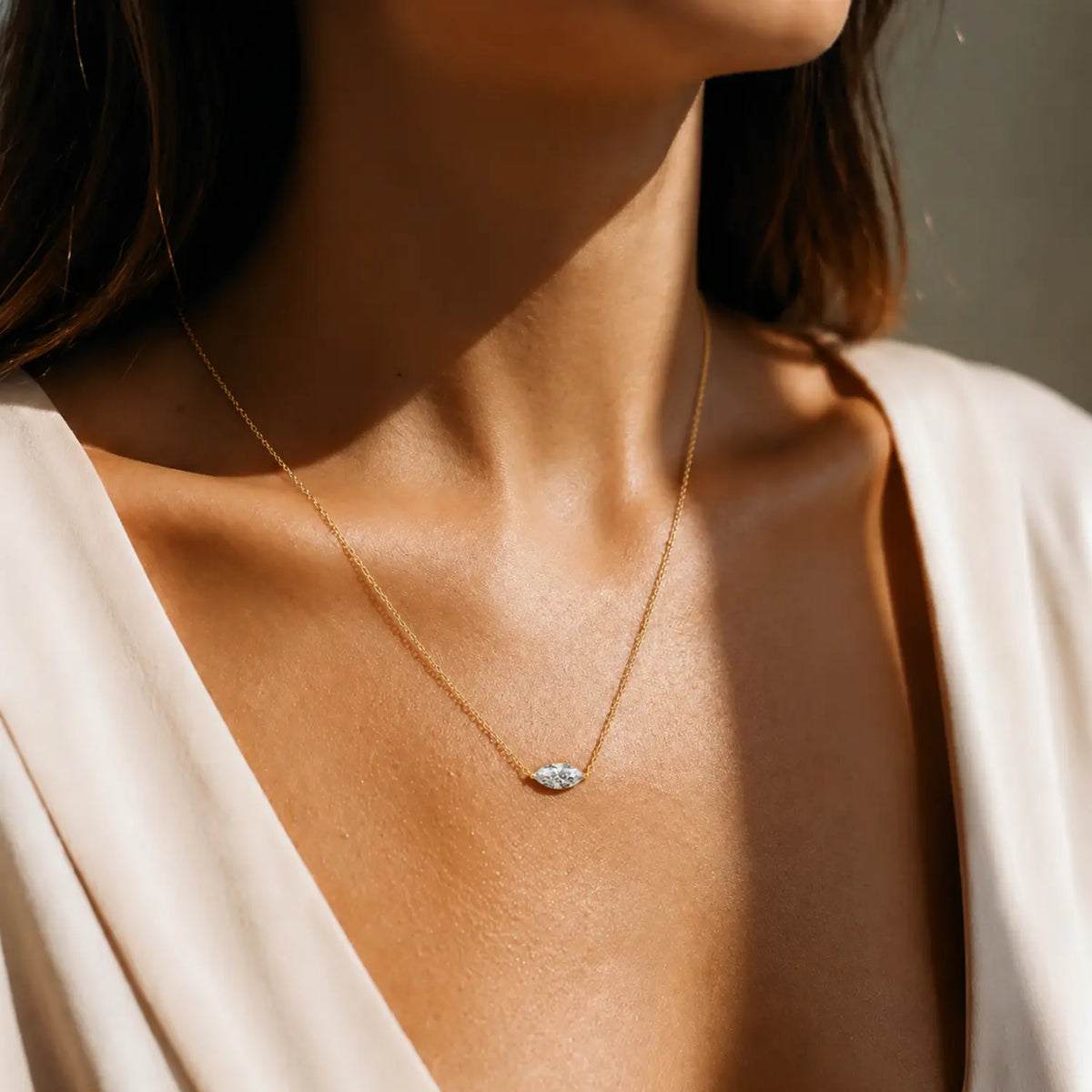 Marquise-cut moissanite necklace with the stone set horizontally between two chain ends.