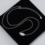 Marquise-cut moissanite necklace with the stone set horizontally between two chain ends.