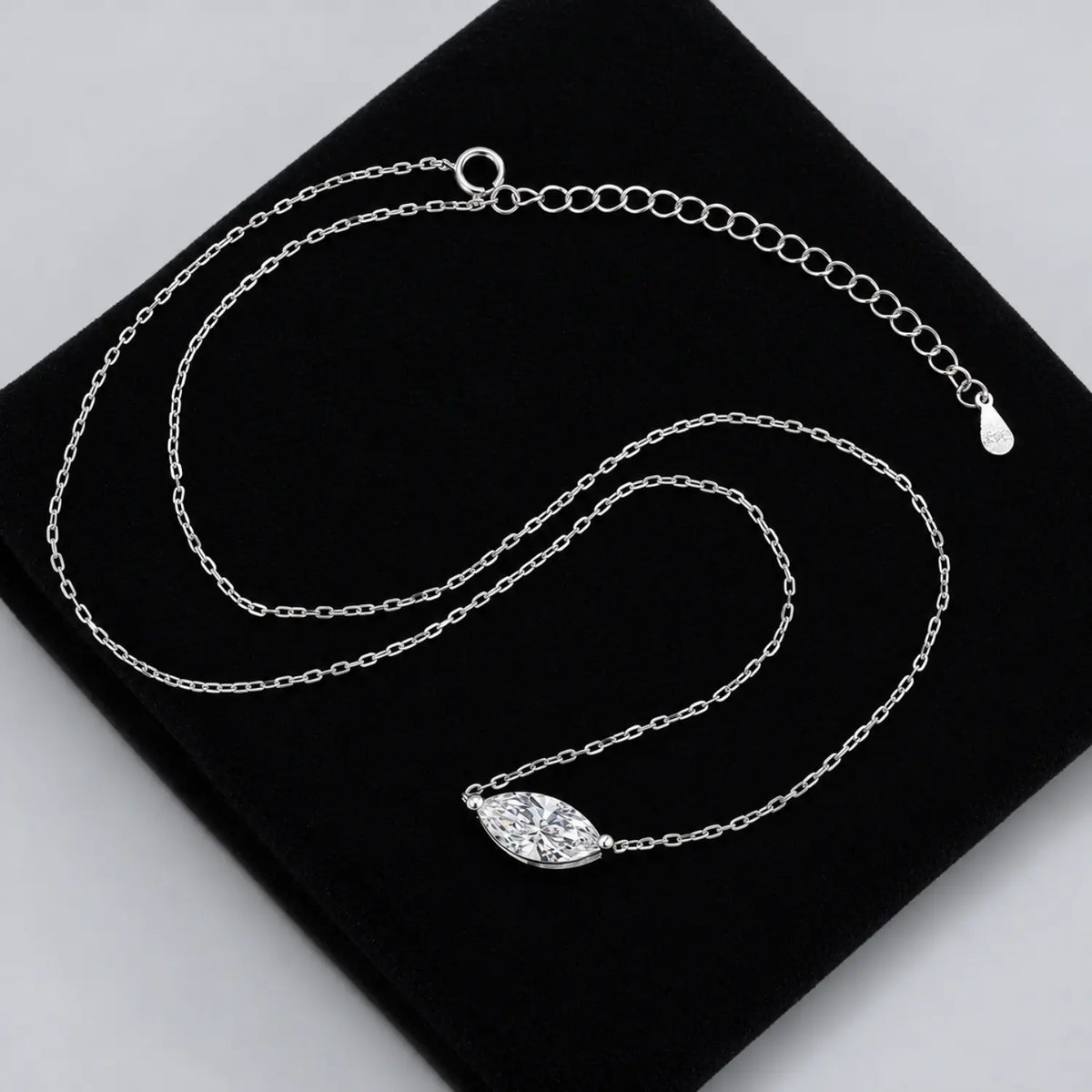 Marquise-cut moissanite necklace with the stone set horizontally between two chain ends.