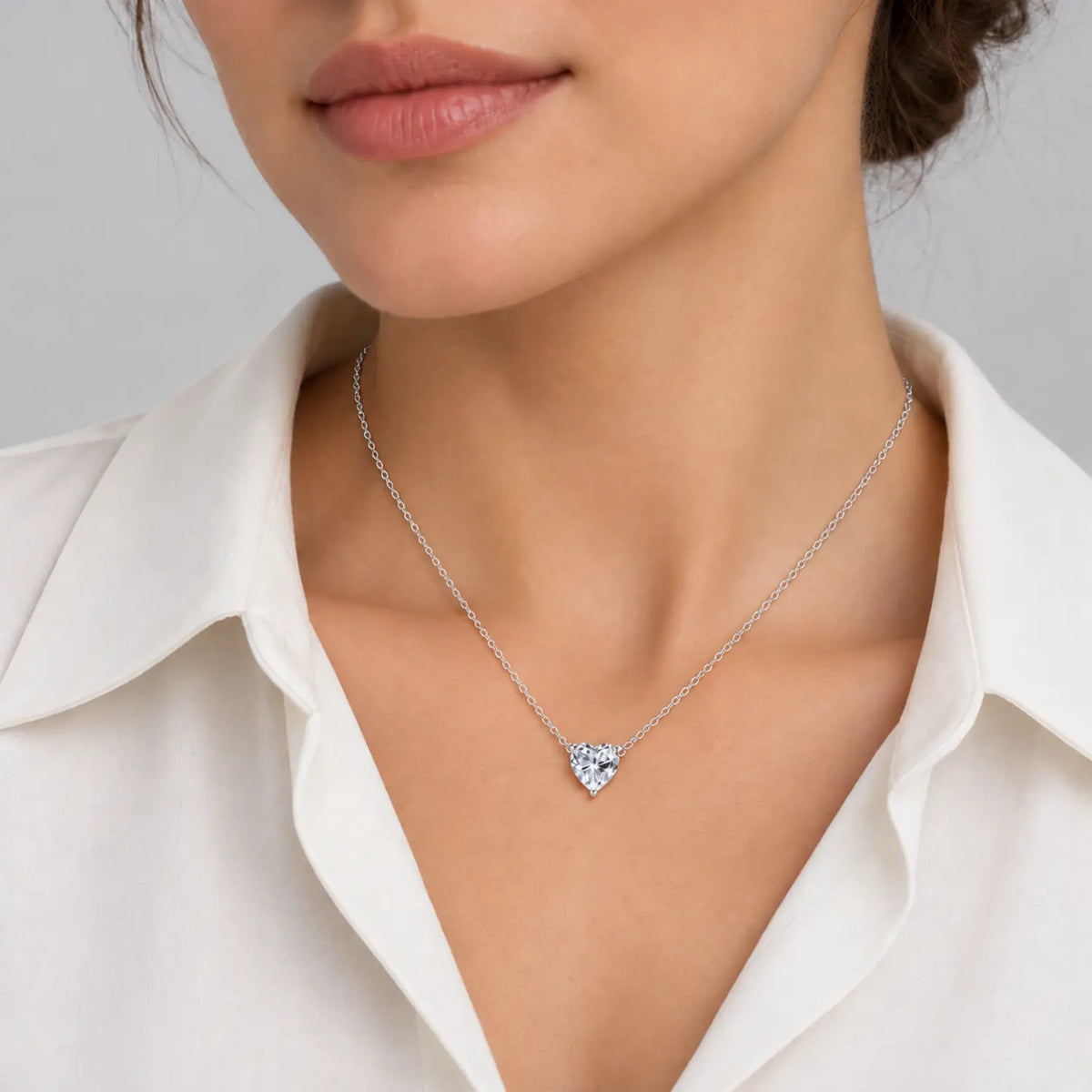 Heart-cut moissanite solitaire necklace with a fine chain attached at both sides.