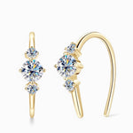 Gold moissanite jewelry earrings with three stones symbolising confidence and love.