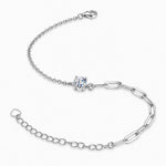 Side view of the silver tone four-prong moissanite solitaire and contrasting chain links