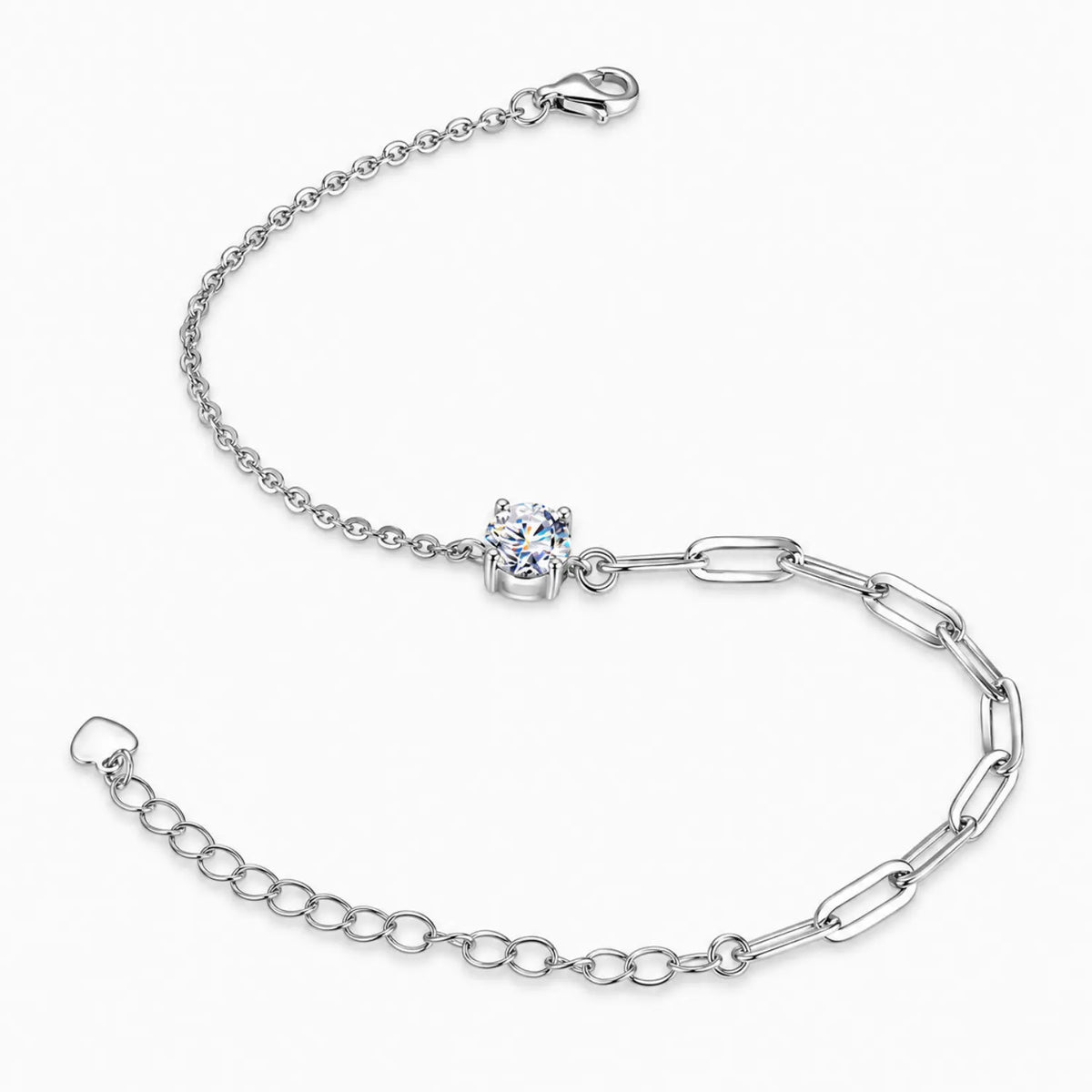 Side view of the silver tone four-prong moissanite solitaire and contrasting chain links