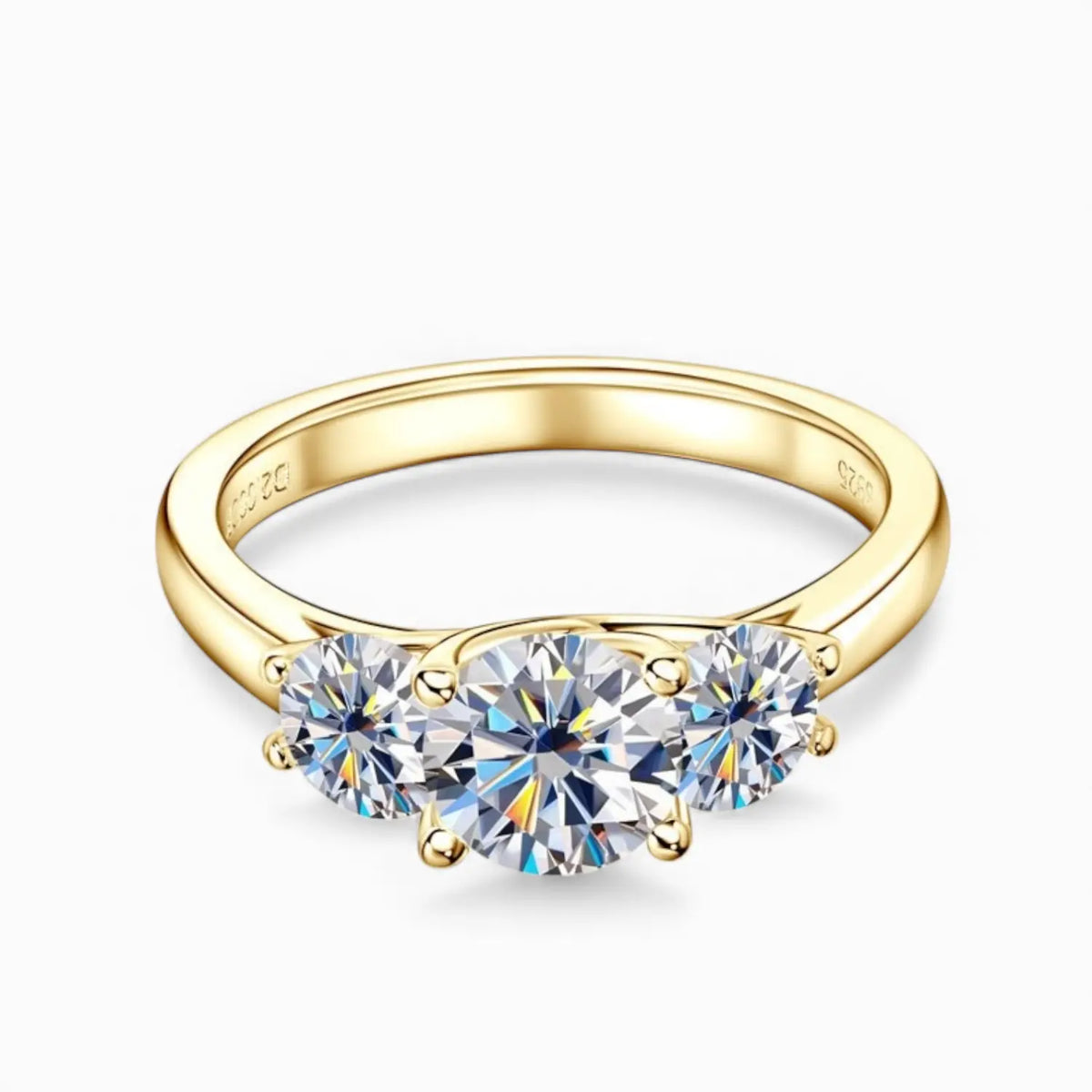 Gold moissanite engagement ring with three stones symbolising love, loyalty and balance.