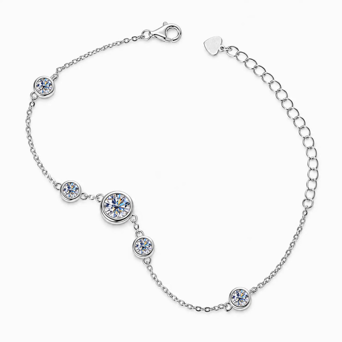 Silver tone bezel-set moissanite station bracelet worn on the wrist