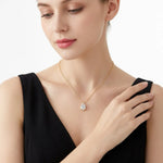 Pear-cut moissanite solitaire pendant on a fine chain.