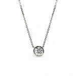 Single round moissanite in a bezel setting with the chain connected at both sides.