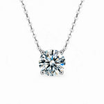 Round moissanite solitaire necklace with a four-prong setting and chain attached at both sides.