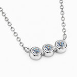 Three round moissanite stones in individual bezel settings arranged horizontally on a chain.