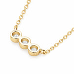 Three round moissanite stones in individual bezel settings arranged horizontally on a chain.