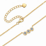 Three round moissanite stones in individual bezel settings arranged horizontally on a chain.
