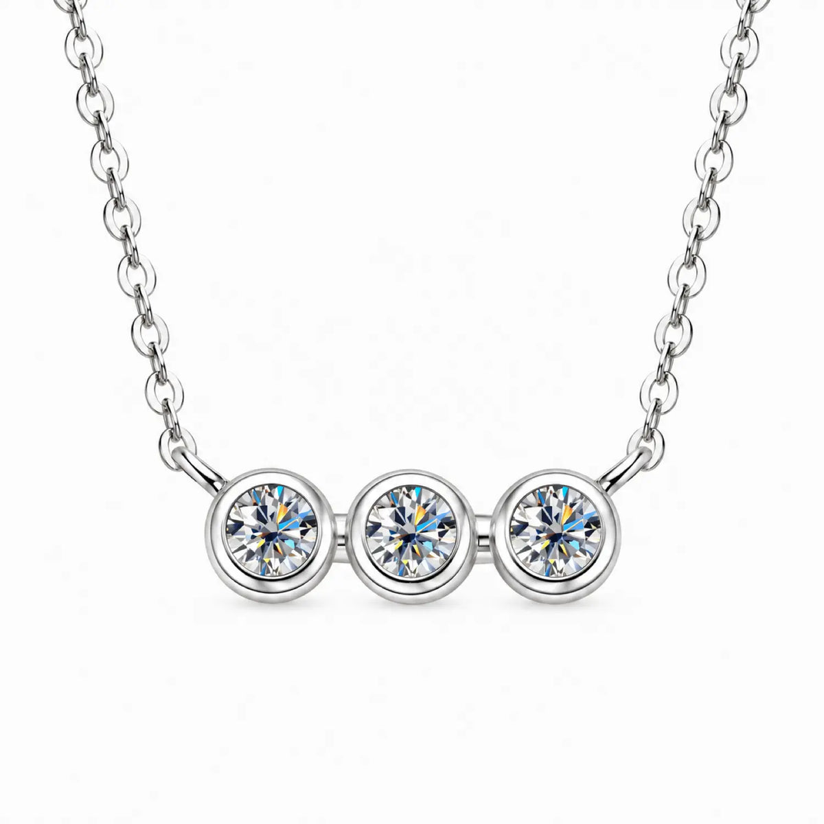 Three round moissanite stones in individual bezel settings arranged horizontally on a chain.