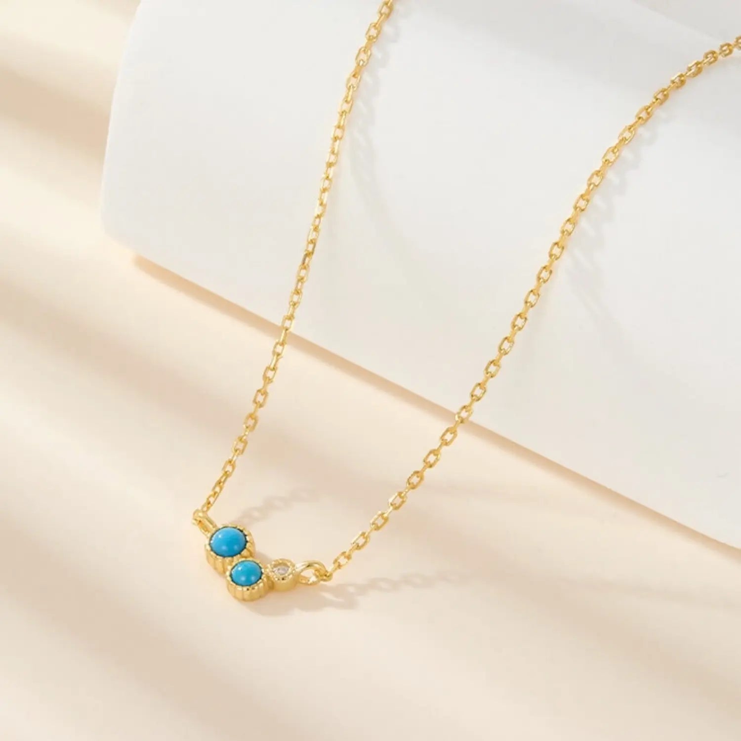 Crescent gold turquoise jewelry necklace symbolising balance, moonlight and gentle luck.